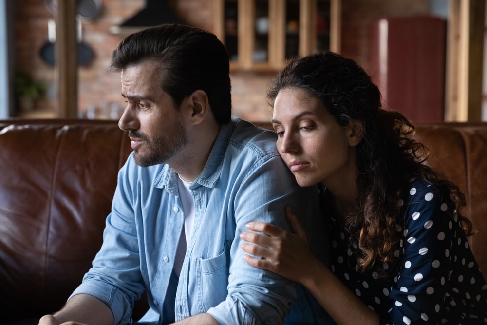Wife expressing empathy and compassion to sad frustrated husband, going through grief, crisis
